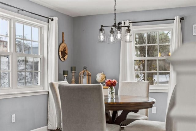 dining room featuring a healthy amount of sunlight and an inviting chandelier