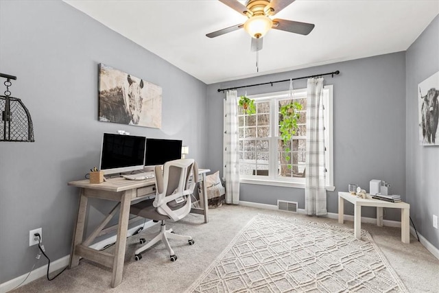 carpeted home office with ceiling fan