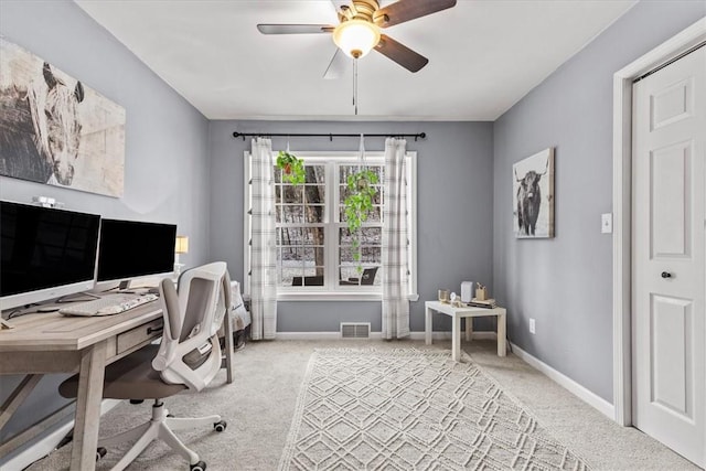 office with ceiling fan and light carpet