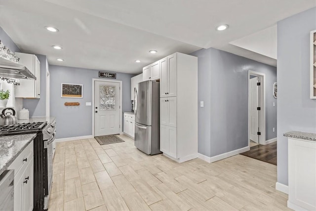 kitchen featuring white cabinets, stainless steel appliances, and light stone counters