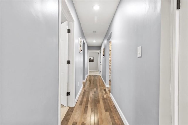 corridor with light hardwood / wood-style floors