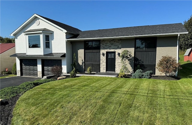 view of front of home featuring a front lawn and a garage