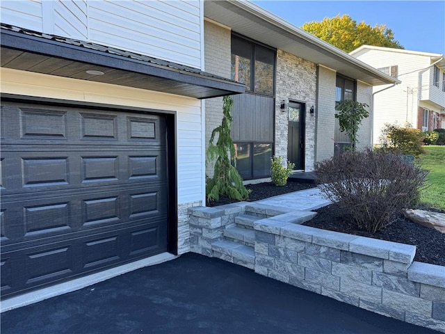 doorway to property with a garage