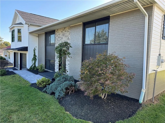 view of home's exterior with a yard and a garage