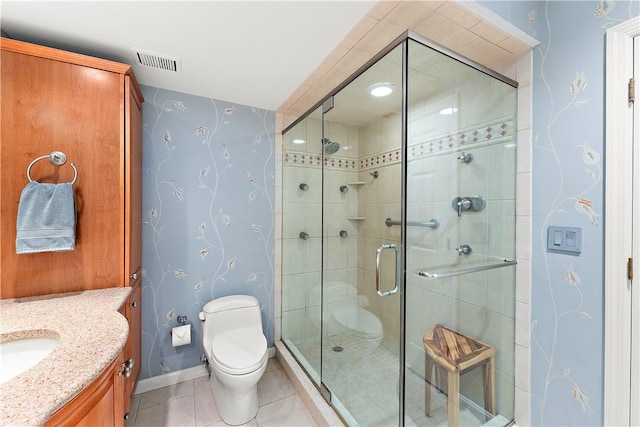 bathroom featuring toilet, an enclosed shower, vanity, and tile patterned floors