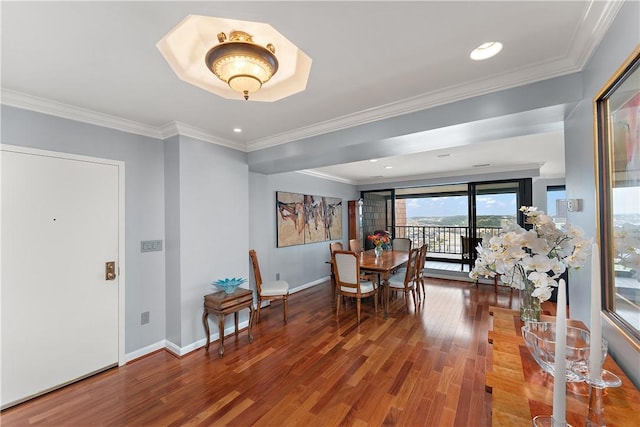 dining room featuring hardwood / wood-style floors and crown molding