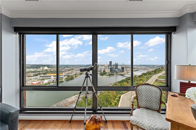 sunroom featuring a water view