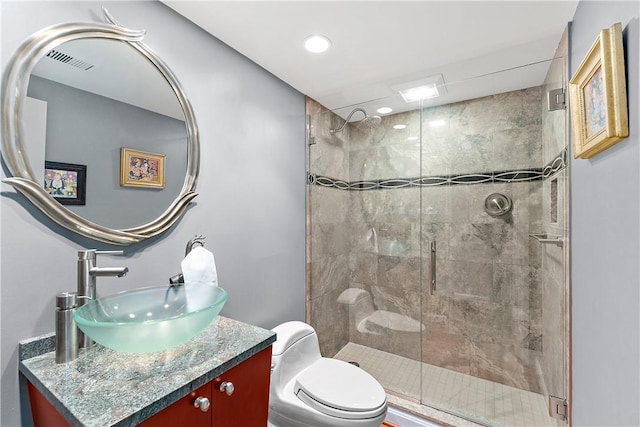 bathroom with an enclosed shower, vanity, and toilet