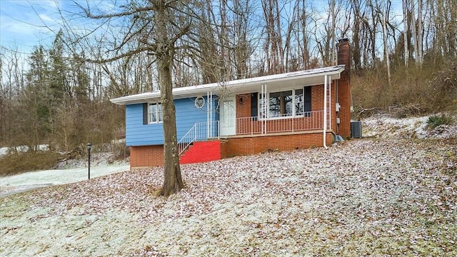 view of front of house with a porch and central AC