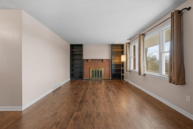 unfurnished living room with a fireplace and dark hardwood / wood-style floors