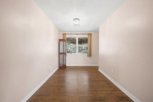 spare room with dark hardwood / wood-style flooring