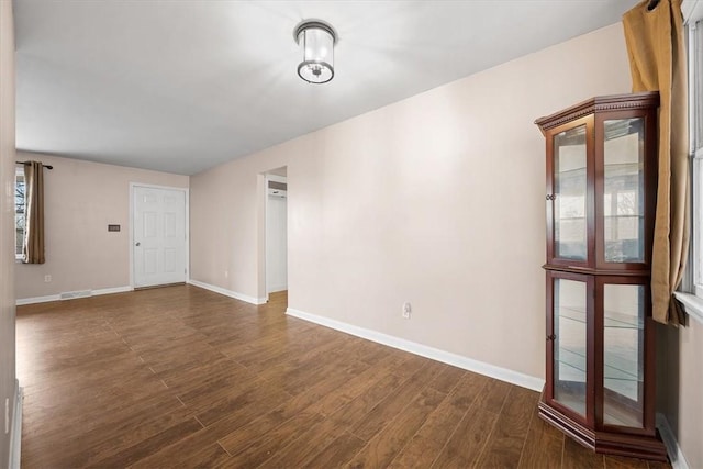 spare room with dark wood-type flooring