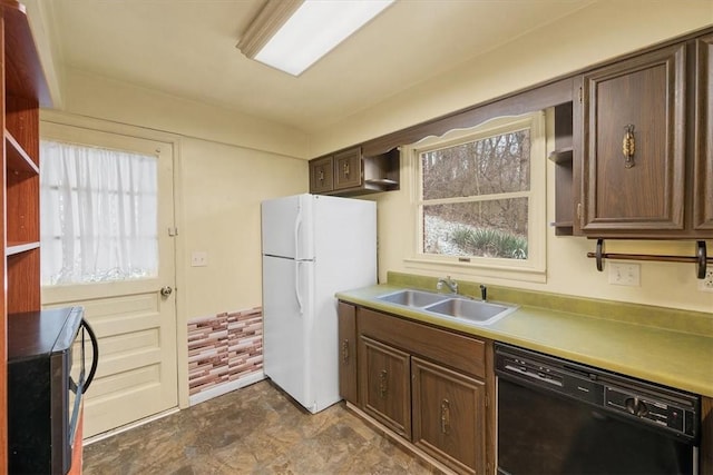 kitchen featuring dishwasher, white refrigerator, a healthy amount of sunlight, and sink