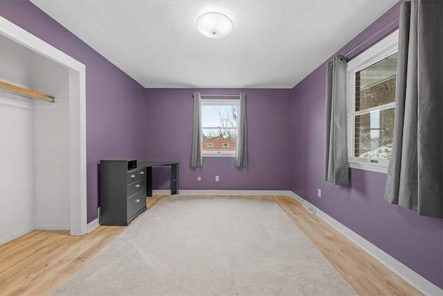 bedroom with hardwood / wood-style flooring and a closet