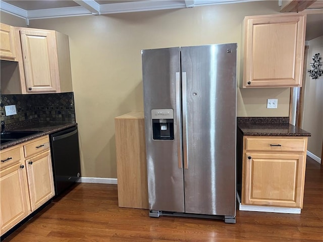 kitchen featuring dishwasher, dark wood-type flooring, stainless steel fridge, dark stone counters, and decorative backsplash