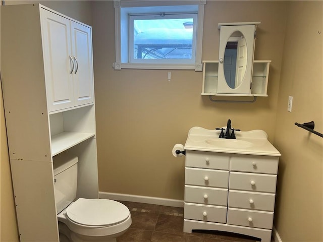 bathroom with tile patterned flooring, vanity, and toilet