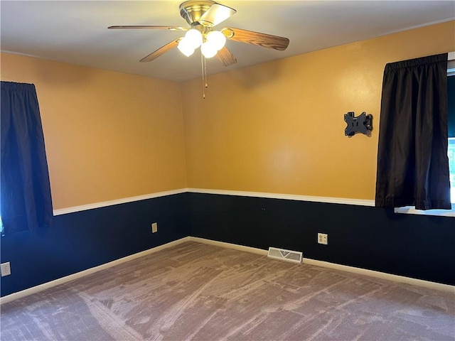 spare room with carpet flooring and ceiling fan