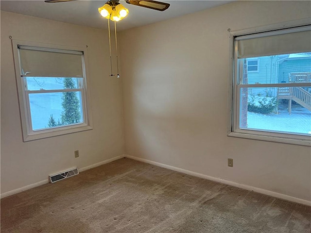 carpeted empty room featuring ceiling fan