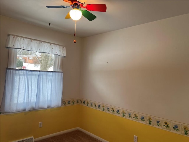 empty room featuring carpet flooring and ceiling fan