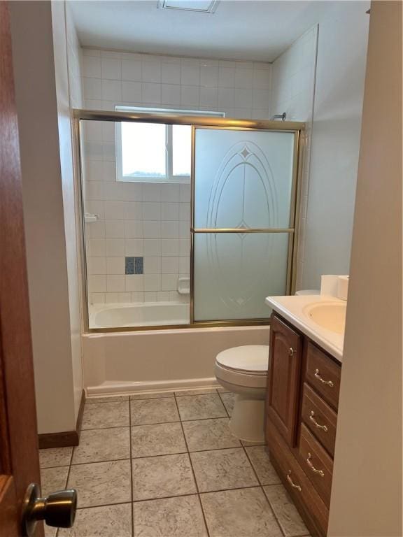 full bathroom featuring combined bath / shower with glass door, vanity, toilet, and tile patterned flooring