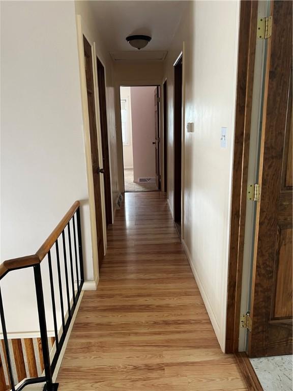 hallway with light hardwood / wood-style floors