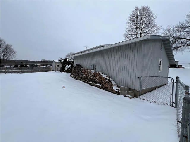 snow covered property with a storage unit