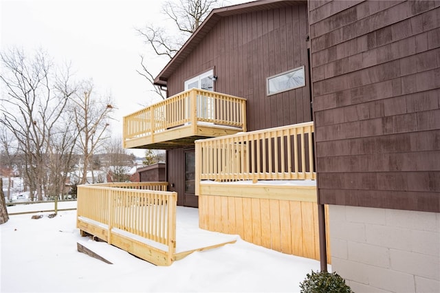 view of snowy exterior with a deck