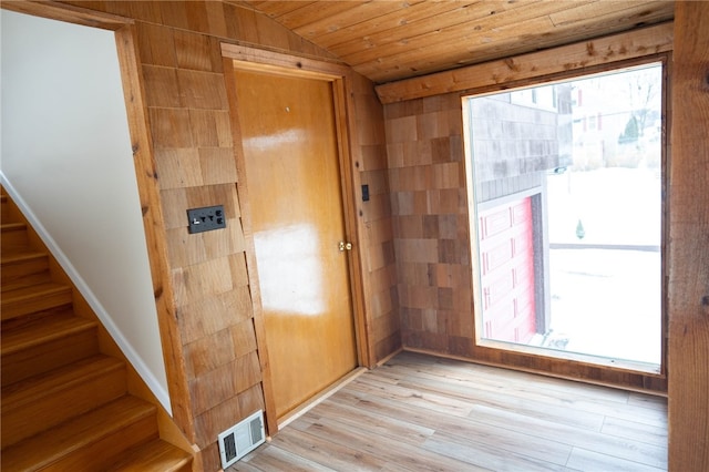 doorway with visible vents, light wood-style flooring, lofted ceiling, wood ceiling, and stairs