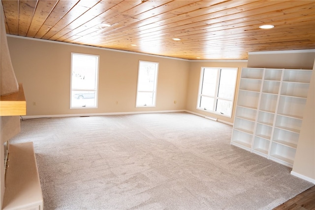 spare room with wood ceiling, ornamental molding, and a healthy amount of sunlight