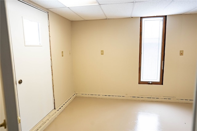 empty room with plenty of natural light and a paneled ceiling