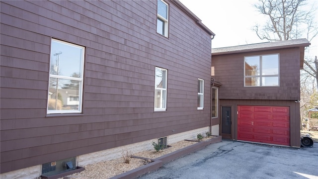 view of home's exterior with a garage and driveway