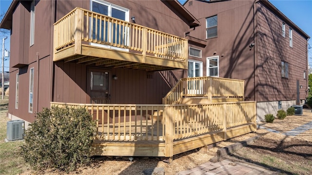 rear view of property with central air condition unit and a deck