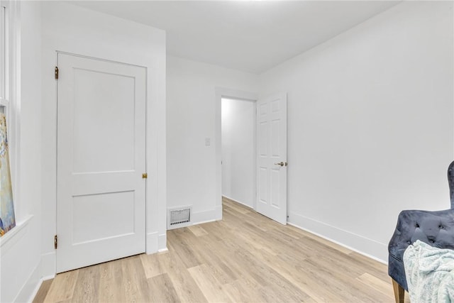 unfurnished bedroom featuring light wood-type flooring, visible vents, and baseboards