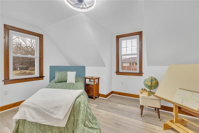 bedroom featuring light hardwood / wood-style floors and lofted ceiling