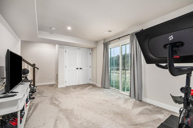 workout room featuring light colored carpet