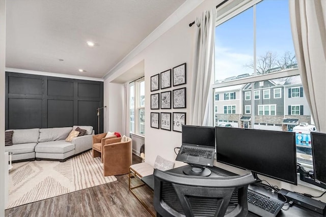 office featuring hardwood / wood-style flooring and crown molding