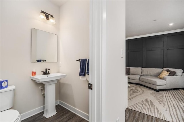 bathroom featuring wood-type flooring and toilet