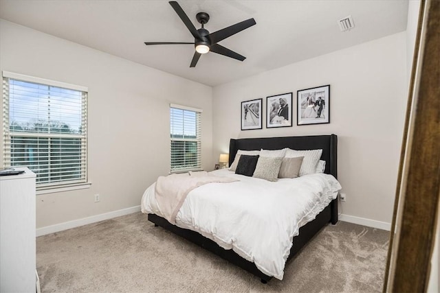 bedroom with ceiling fan and light colored carpet