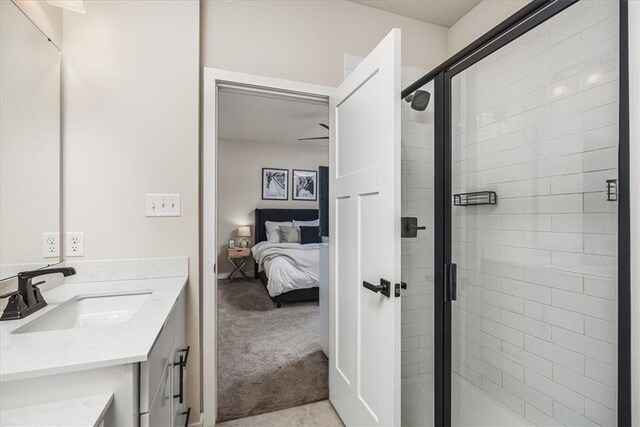 bathroom featuring walk in shower and vanity