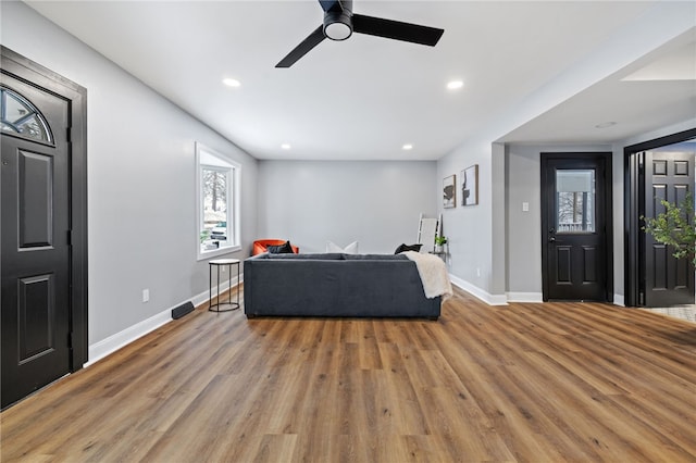 living room with ceiling fan and hardwood / wood-style floors