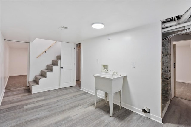 basement featuring light hardwood / wood-style flooring