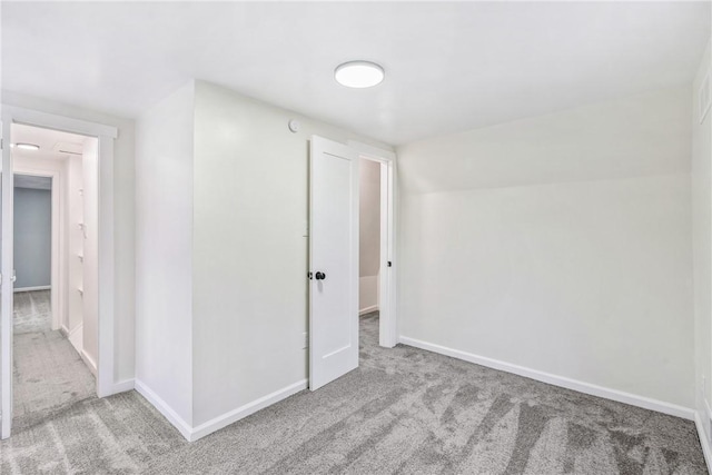 carpeted spare room featuring lofted ceiling