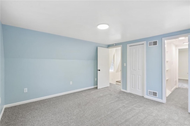 unfurnished bedroom with light colored carpet, vaulted ceiling, and a closet