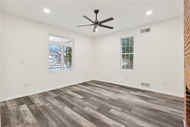 empty room featuring ceiling fan and dark wood-type flooring