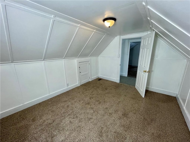 bonus room with carpet and vaulted ceiling