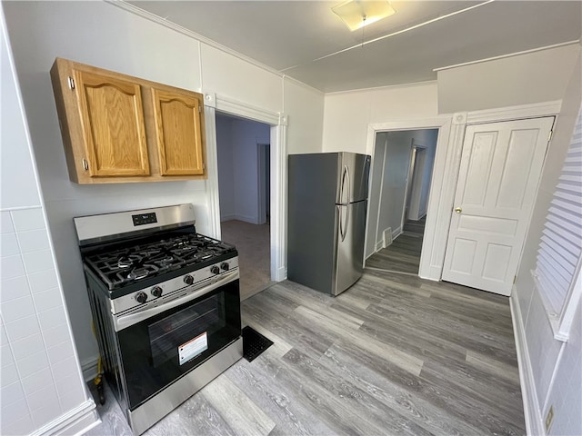 kitchen with light wood-type flooring and appliances with stainless steel finishes