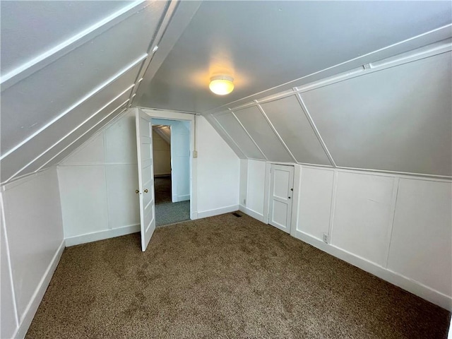 bonus room with carpet flooring and vaulted ceiling