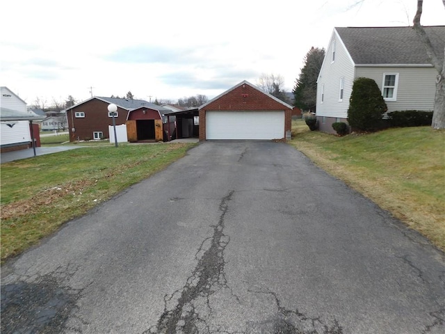 view of front of house with an outbuilding, a front lawn, and a garage