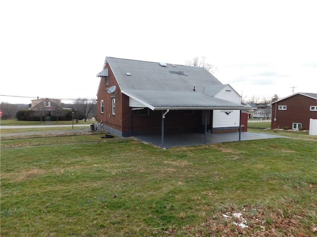 rear view of house featuring a yard and central AC