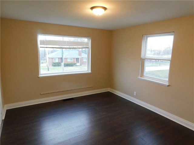 spare room featuring dark hardwood / wood-style floors